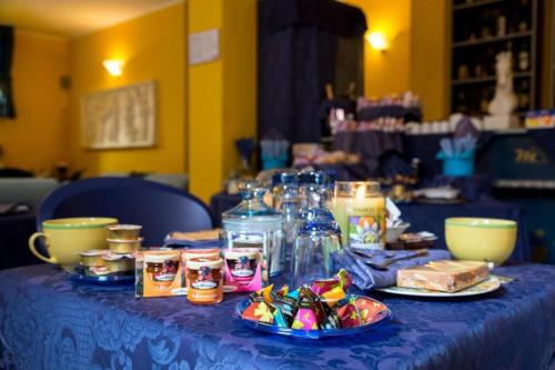 a blue table topped with plates of food and drinks at Hotel Motel Residence S in Front