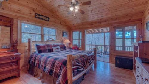 - une chambre avec un lit dans une cabane en rondins dans l'établissement Wilderness Way, à Blue Ridge