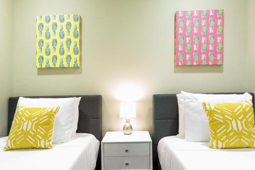 two beds sitting next to each other in a room at LiivUP Warehouse Apartments in New Orleans