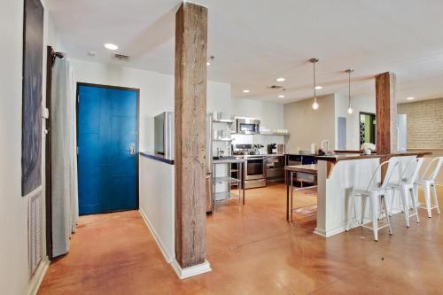 a kitchen with a blue door and a table and chairs at LiivUP Warehouse Apartments in New Orleans