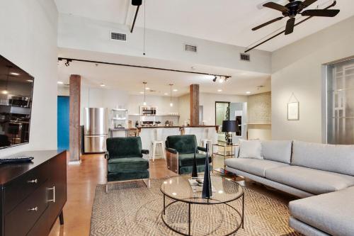 a living room with a couch and a table at LiivUP Warehouse Apartments in New Orleans