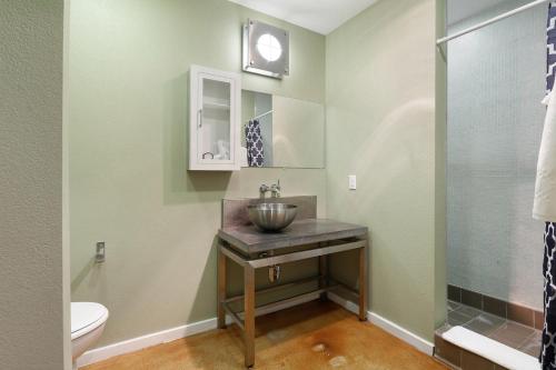 a bathroom with a sink and a toilet at LiivUP Warehouse Apartments in New Orleans