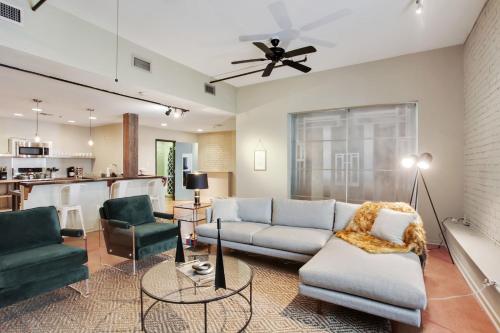 a living room with a couch and two chairs at LiivUP Warehouse Apartments in New Orleans
