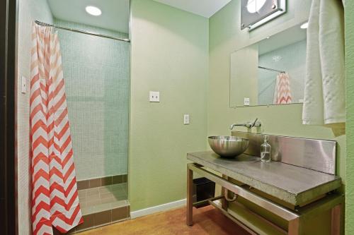 a bathroom with a bowl sink and a shower at LiivUP Warehouse Apartments in New Orleans