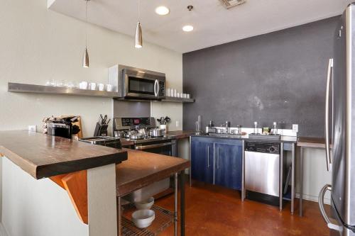 a large kitchen with a blackboard on the wall at LiivUP Warehouse Apartments in New Orleans