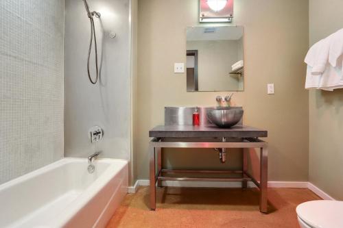 a bathroom with a sink and a bath tub at LiivUP Warehouse Apartments in New Orleans