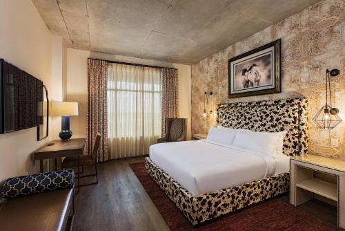 a hotel room with a bed and a desk at The Brownwood Hotel & Spa in The Villages