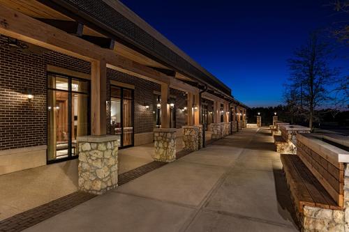 a row of benches outside of a building at night at The Brownwood Hotel & Spa in The Villages