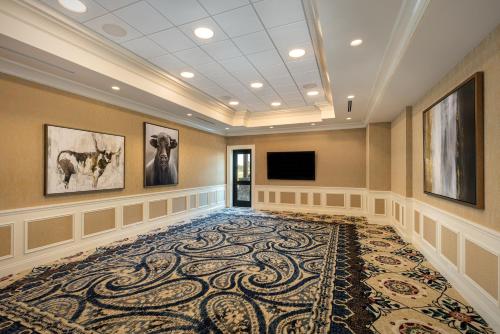 a large room with a large rug and a flat screen tv at The Brownwood Hotel & Spa in The Villages