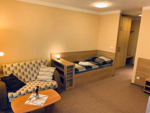 a room with a bed and a couch and a table at Výšinka 719 in Turnov