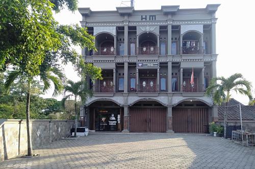 a large building with a gate in front of it at KoolKost Syariah near Stasiun Tanjung Karang Lampung in Bandar Lampung