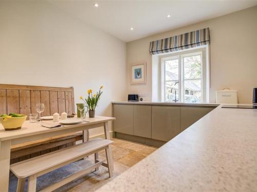 a large kitchen with a table and a window at The Old Dairy in Burford