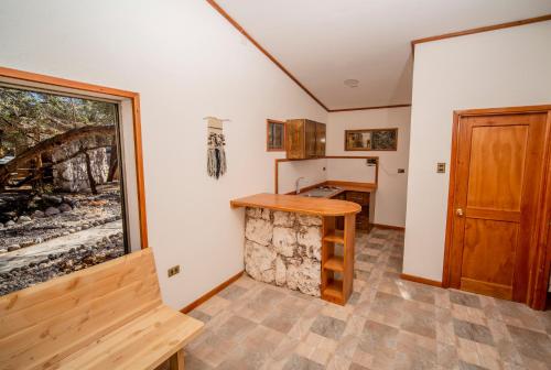 a kitchen with a counter and a window at Tantakuy Eco Experience Hotel in La Huaica