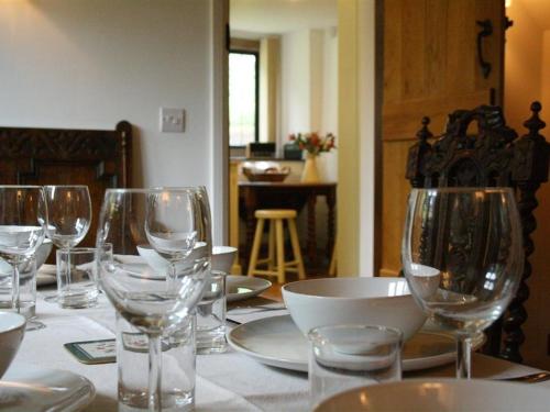 a table with wine glasses and plates on it at Tumbledown in Broadway