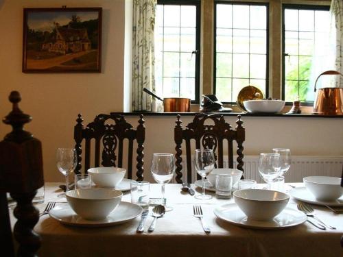 a table with plates and bowls and glasses on it at Tumbledown in Broadway