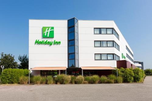 a white building with a holiday inn sign on it at Holiday Inn - Strasbourg - Nord by IHG in Schiltigheim
