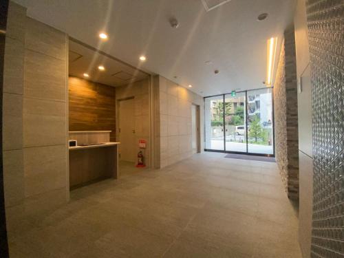 a hallway of a building with a large glass door at Randor Residential Hotel Fukuoka Annex in Fukuoka