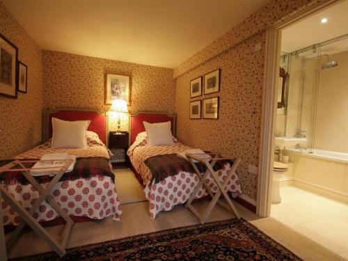 A bed or beds in a room at Thorndale Farm Barn 12 Stable Cottage