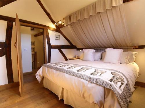 um quarto com uma grande cama branca num quarto em Elephant Cottage em Edwin Loach