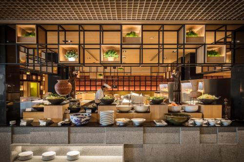 a chef in a kitchen preparing food in a kitchen at Holiday Inn Bangkok by IHG in Bangkok
