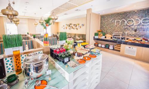 a bakery with a buffet of food on a counter at MENA Plaza Hotel Albarsha At The Mall in Dubai