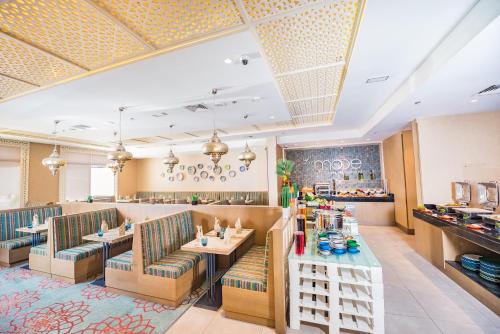 a restaurant with chairs and tables in a room at MENA Plaza Hotel Albarsha At The Mall in Dubai