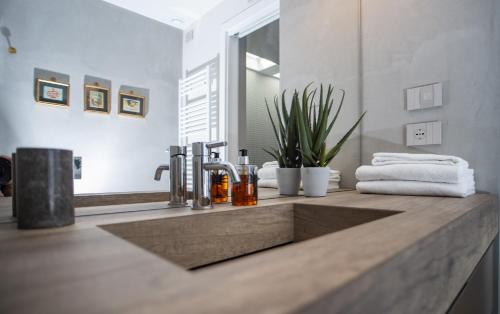 a bathroom counter with a sink and a mirror at Agrisuite Il Cedro in La Morra