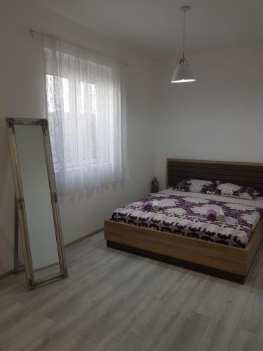 a bedroom with a bed and a mirror in it at Modern Apartment Doris in Kotor