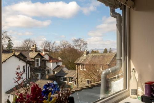 a window with a view of houses and buildings at Holly Lodge Guest House with FREE off site health club in Windermere