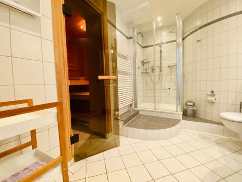 a bathroom with a shower and a toilet and a sink at Villa Seepark - Ferienwohnung 2 in Heringsdorf