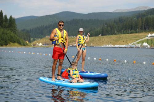 a group of people on paddle boards on a lake at Bukovel Apart in Bukovel