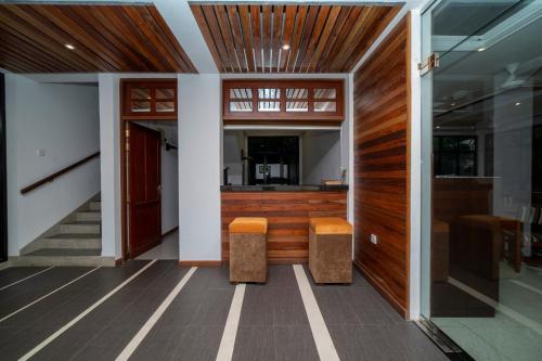 a hallway of a house with two stools at Spring Villas Kandy in Kandy