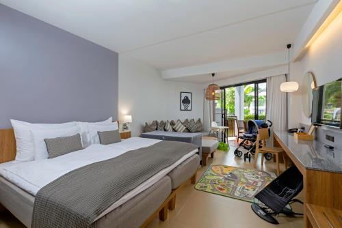 a bedroom with a large bed and a living room at Sunwing Kamala Beach in Kamala Beach