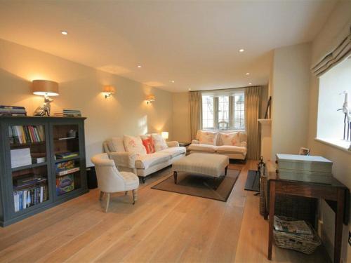 a living room with a couch and a table at Hillside Cottage in Burford