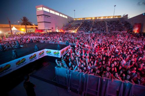 a large crowd of people sitting in stands at a concert at Hotel Romerito in Málaga
