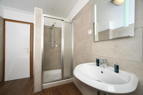 a bathroom with a sink and a shower at Andrea in Leogang