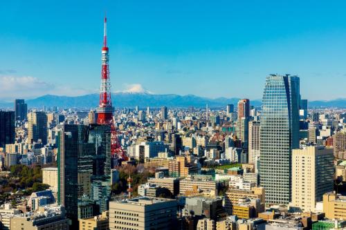 a view of a large city with a tall tower at Park Hotel Tokyo in Tokyo