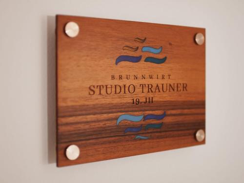 a sign for a photography studiourer on a wall at Brunnwirt ESSEN & WOHNEN in Fuschl am See