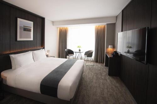a hotel room with a large bed and a television at Orakai Daehakro Hotel, BW Signature Collection in Seoul