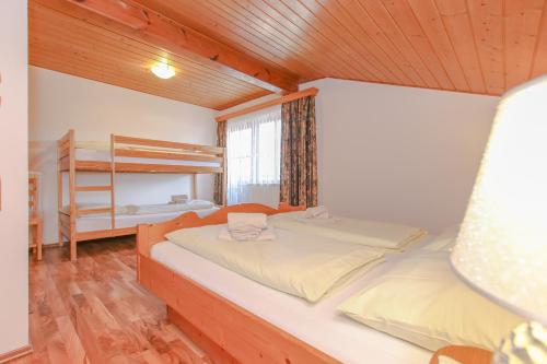 a bedroom with a bed and a bunk bed at Appartements Schmidsendl in Lofer