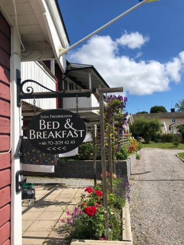 a sign for a bed and breakfast on the side of a building at Sven Fredriksson Bed & Breakfast in Norrtälje