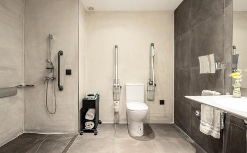 a bathroom with a toilet and a shower and a sink at Ilunion Hacienda de Mijas in Mijas