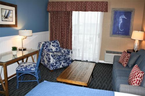 a living room with a couch and a chair at Avenue Inn & Spa in Rehoboth Beach