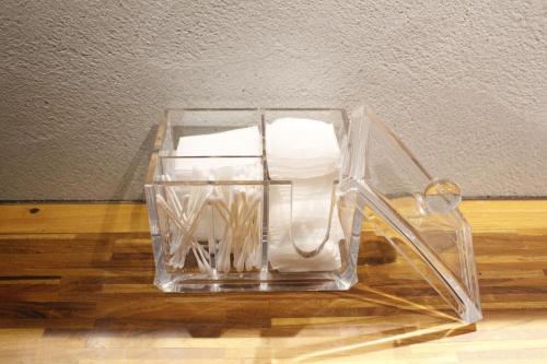 a clear glass container with paper towels in it at HARE-TABI SAUNA & INN Yokohama - ハレタビ - in Yokohama