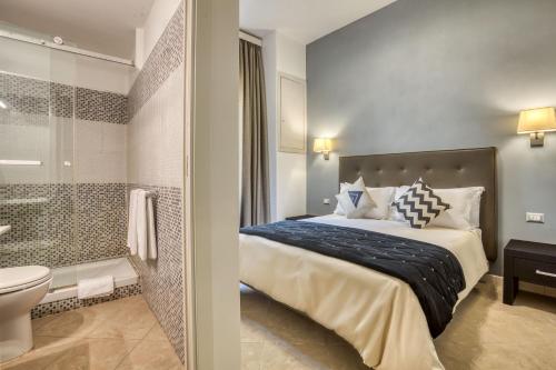a bedroom with a bed and a bathroom with a shower at Ada Rooms in Rome