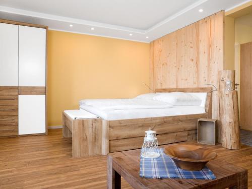 a bedroom with a bed with a wooden wall at App Seaside in Insel Poel