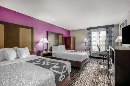 a hotel room with two beds and purple walls at La Quinta Inn by Wyndham North Myrtle Beach in Myrtle Beach