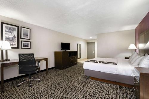 a hotel room with a bed and a desk at La Quinta Inn by Wyndham North Myrtle Beach in Myrtle Beach