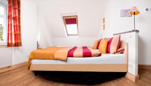 a bedroom with a bed with colorful pillows at Einhusen Kornkammer in Einhusen