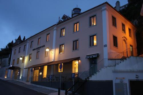a large white building with its lights on at Sintra Boutique Hotel in Sintra